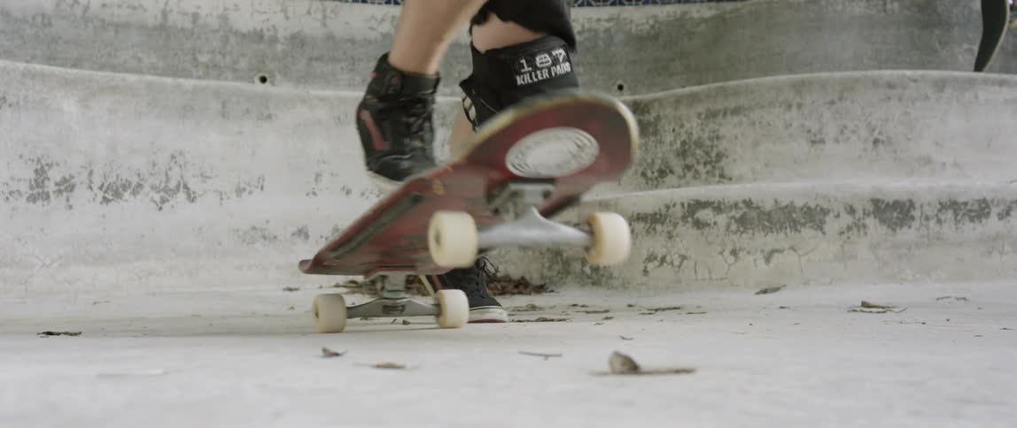 Boy with knee pads on skateboard