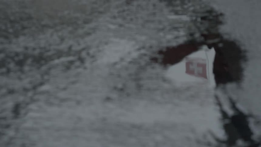 A person walking across a frosted camera