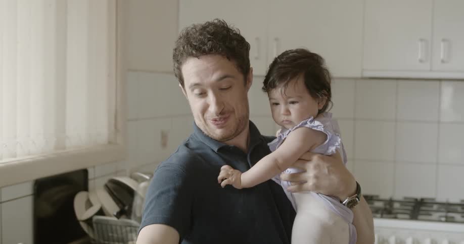 A young girl spills coffee on a man