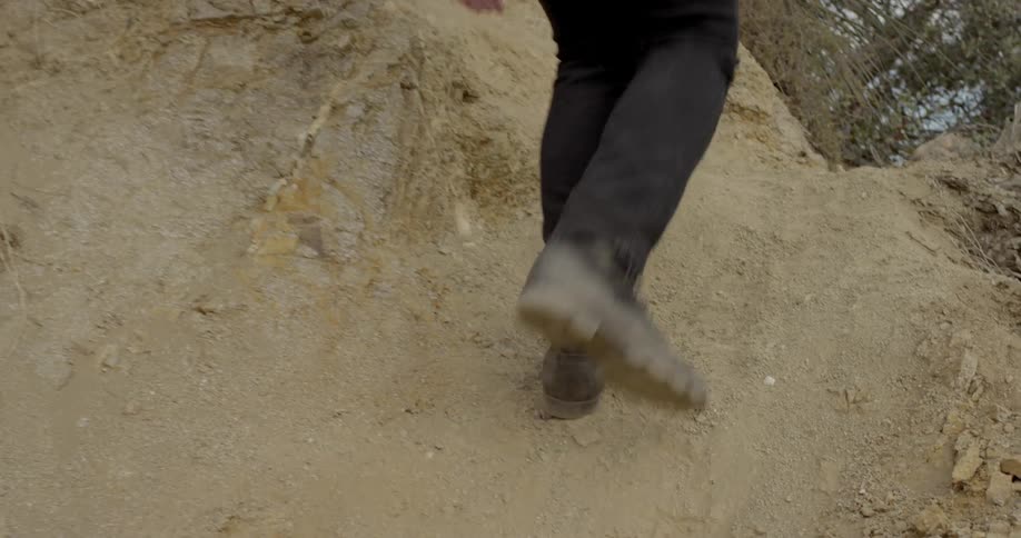 A man climbs up a hill