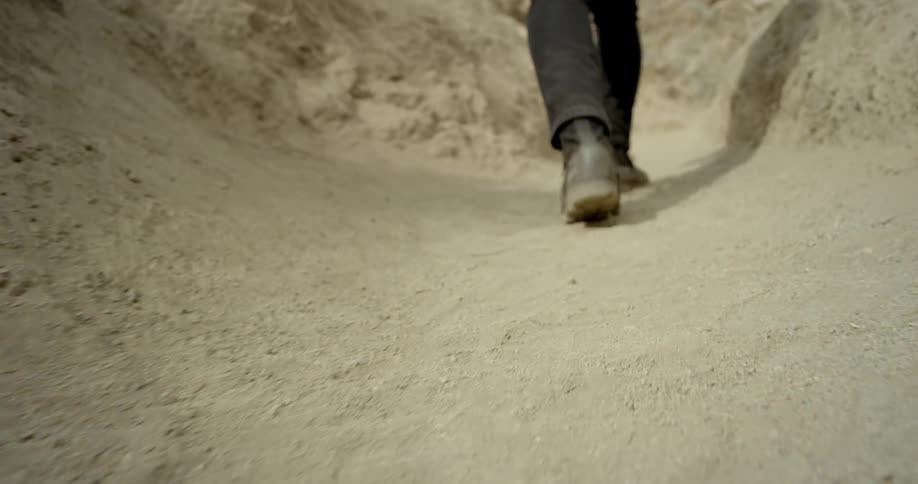 A man walks along a dirt path