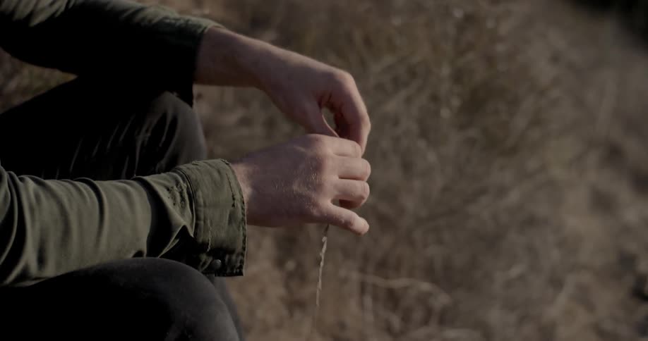 A man plays with a stick