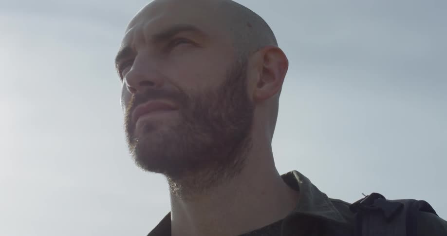 A man stands outside and looks around