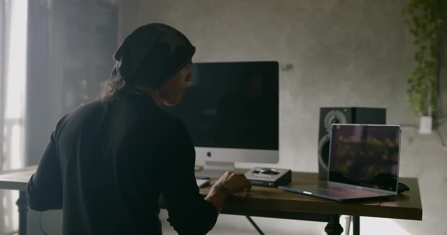 A man sits in front of his computers