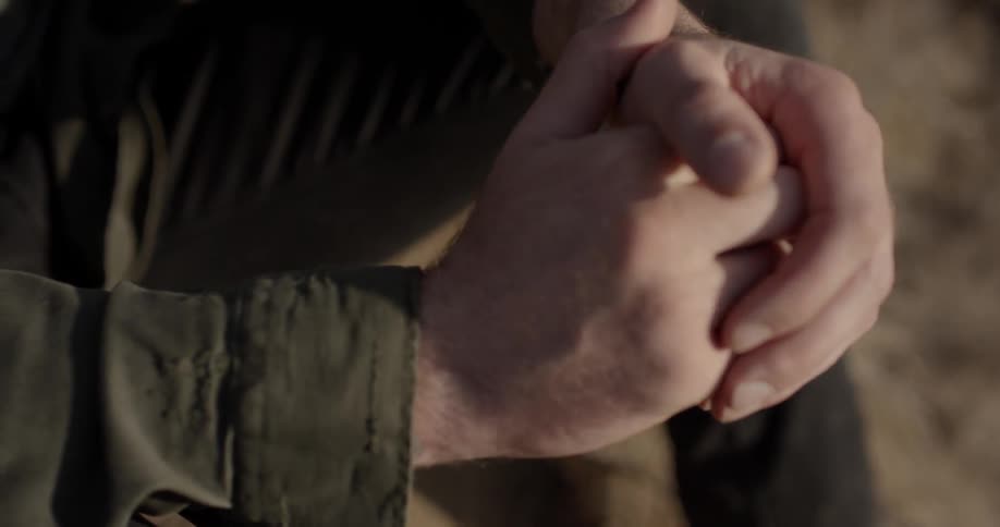 A man rubs his hands together