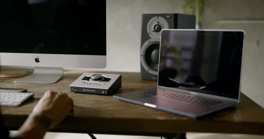 A man sits at a computer workstation in a room