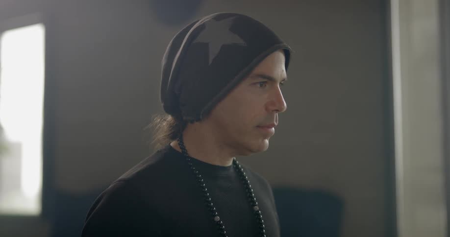 A man nods while looking ahead