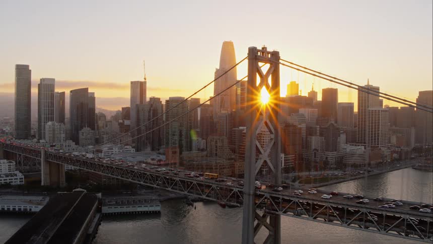 Cars move across the large bridge in the middle of the city