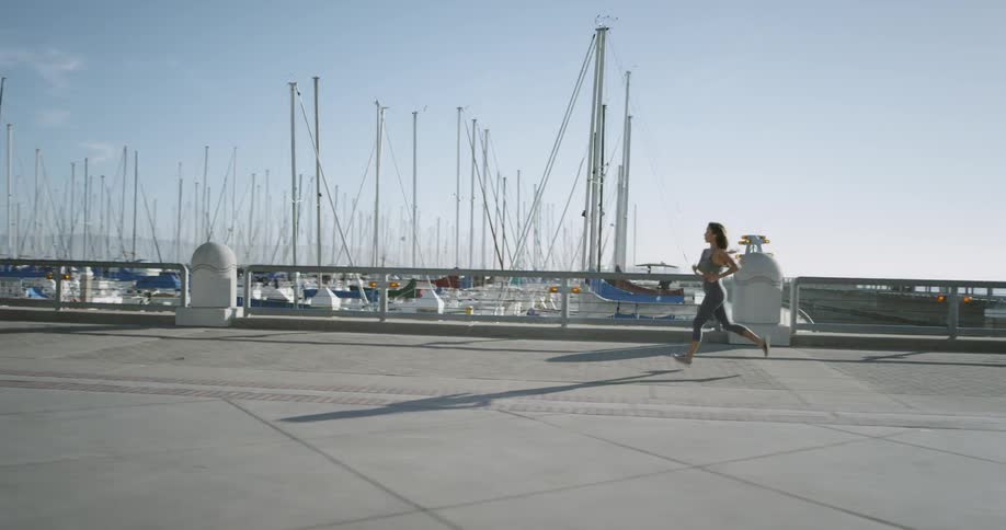 A woman is jogging outdoors