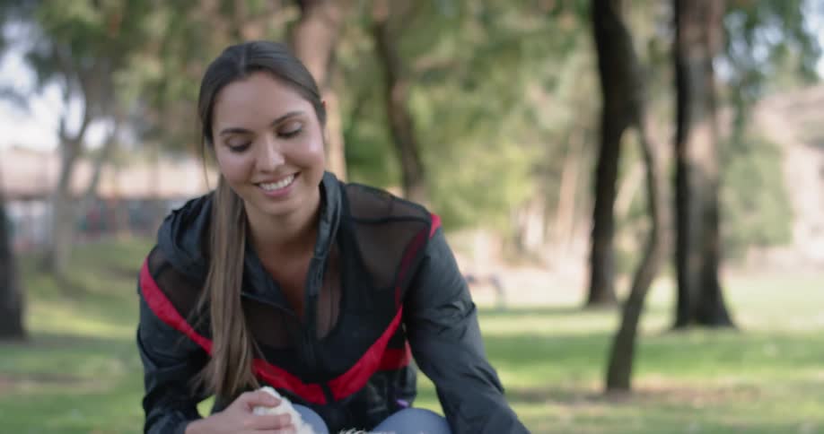 A woman petting a dog in a park during the day