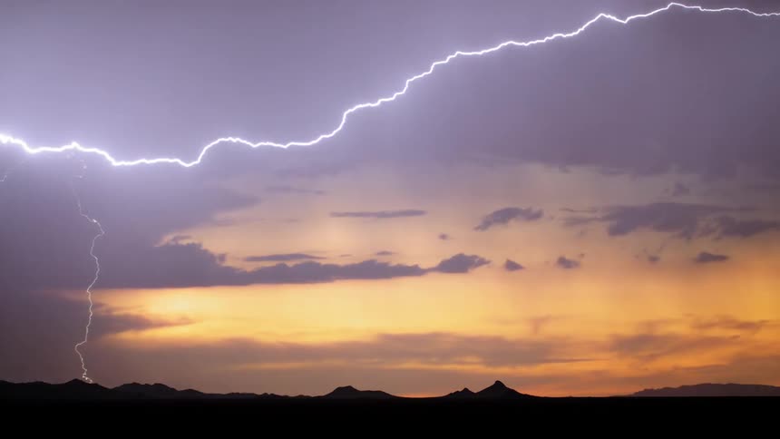 A massive burst of lightning streaks across the sky