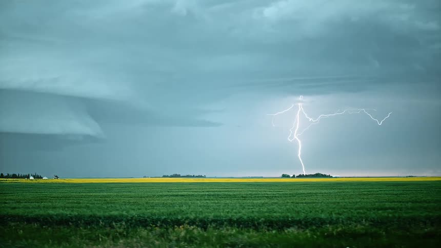 Grasslands with the sky and lightning in the background