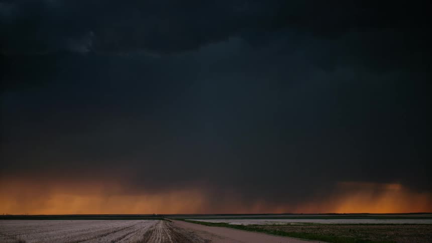 Rain bands and lightning filled clouds over flat land