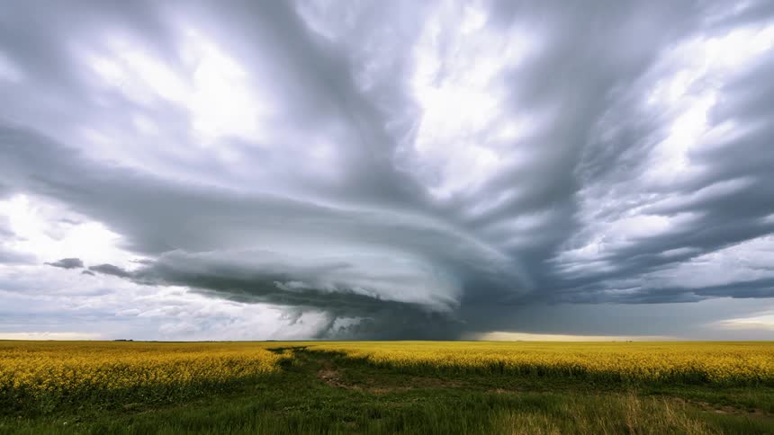 Tornado supercell storm rolls through the plain with lighting