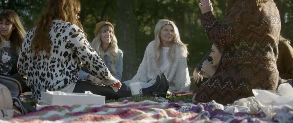 A group of women have a picnic in a park