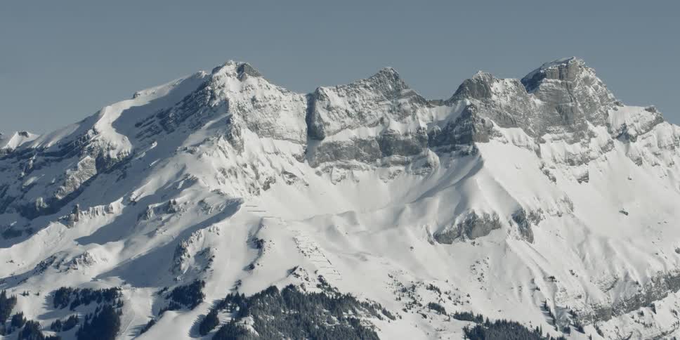 A snowy mountain ridge during the day