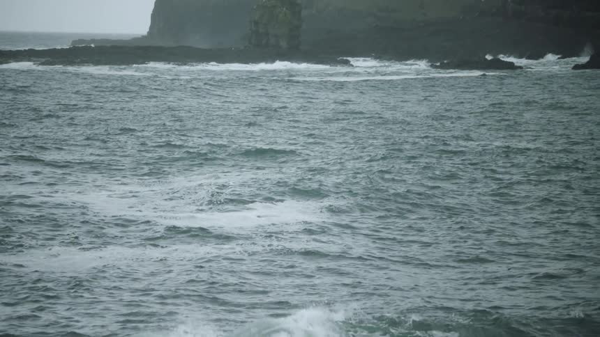 View of heavy waves breaking on a rocky shore