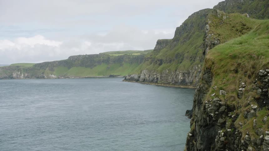 Grass covered cliffs of a bay during the day