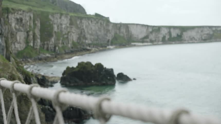 Rope barrier overlooking ocean and cliffs