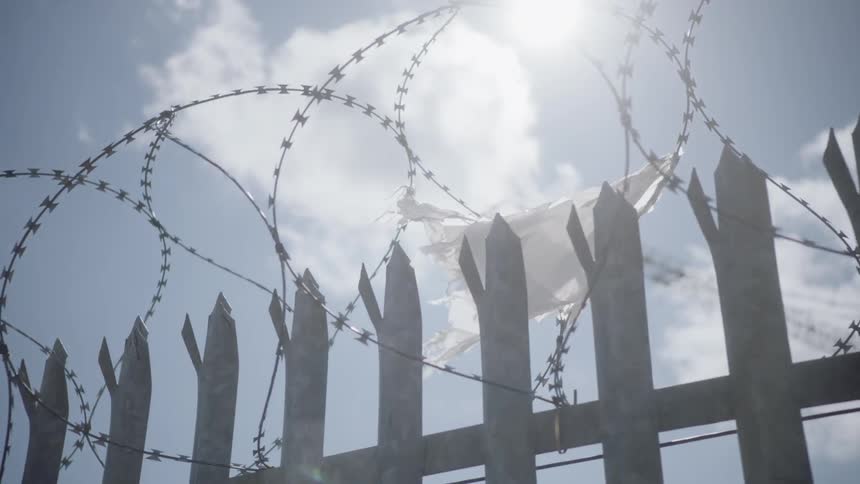 Barbed wire attached to a fence