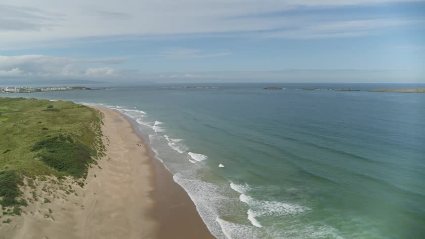 Waves washing up on a narrow beach