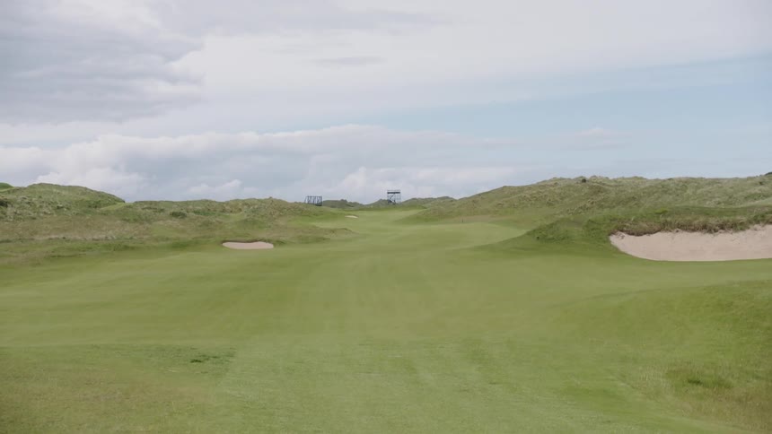 A golfing green with sand banks during the day