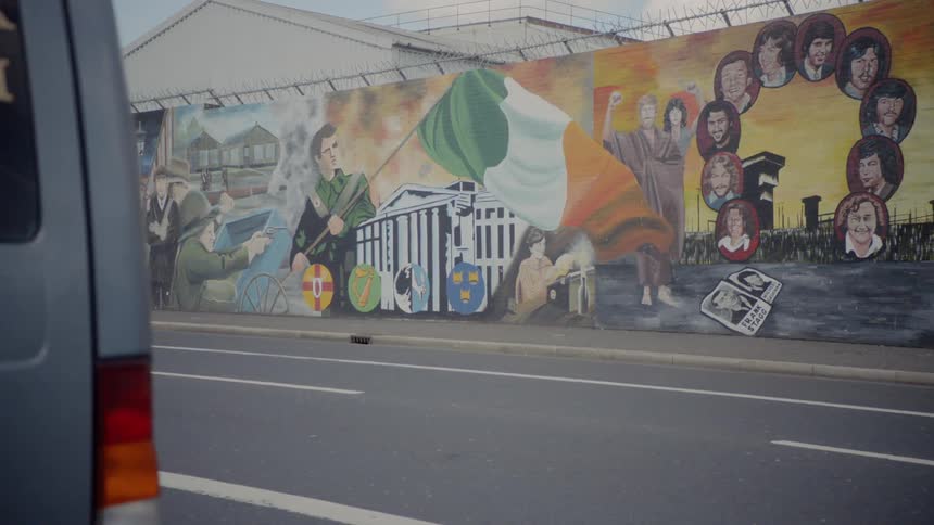 Graffiti on the side of a wall containing political figures and actions