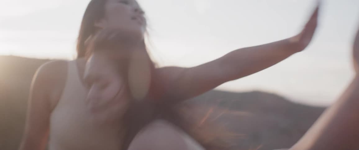 Two women dancing under the sun