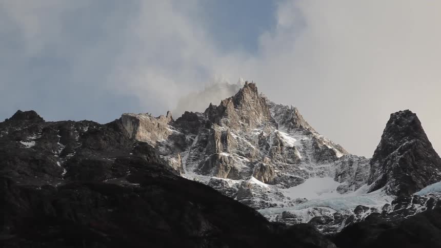 Mist arises from a mountain peak