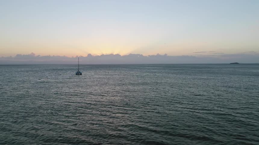 A single ship sailing in the ocean water
