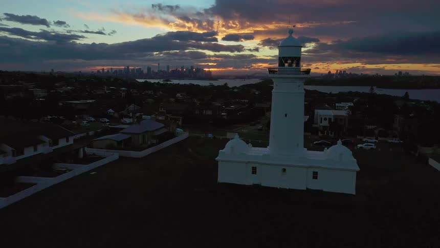 The sun is setting in the horizon of a city