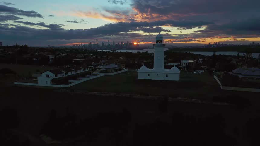 It is a light house and it lights up against weather in the sky