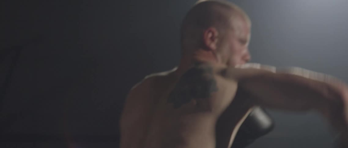 Two boxers throw punches at each other
