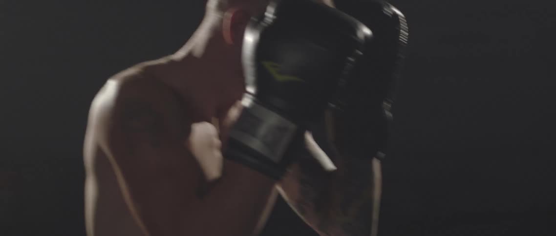 Two men are throwing punches boxing each other