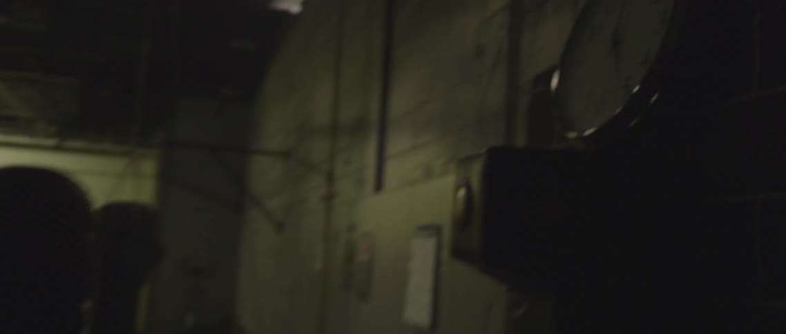 A fighter walks into a gym equipped with boxing and fighting equipment