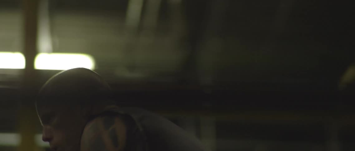 A man shadow boxing in a ring inside of a studio