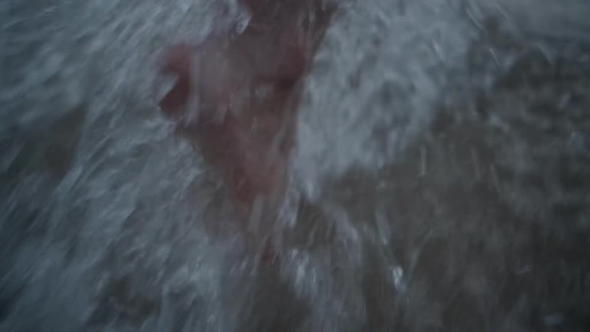 Person runs through surf