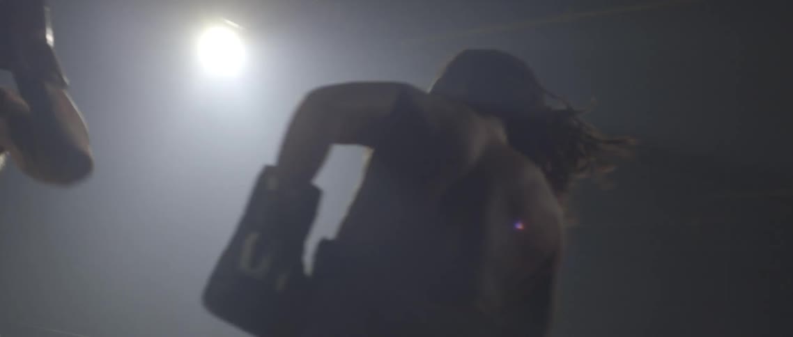 Two boxers exchange punches in a ring
