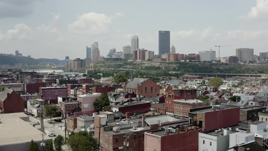 A neighborhood with buildings and skyscrapers in the background