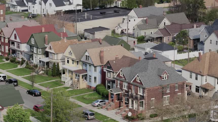 A suburb of a city with a variety of houses and vehicles