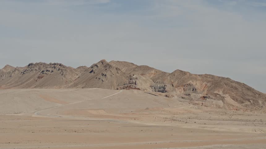The mountains are past the flat desert