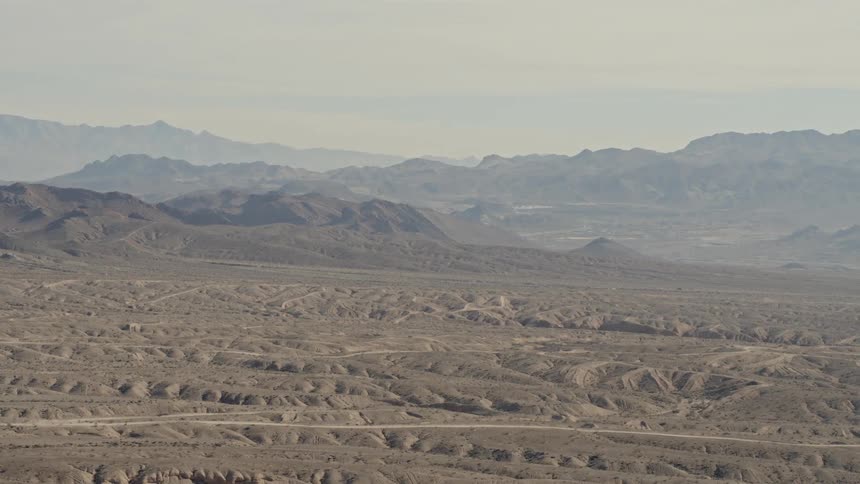 The desert is full of hills on a foggy day