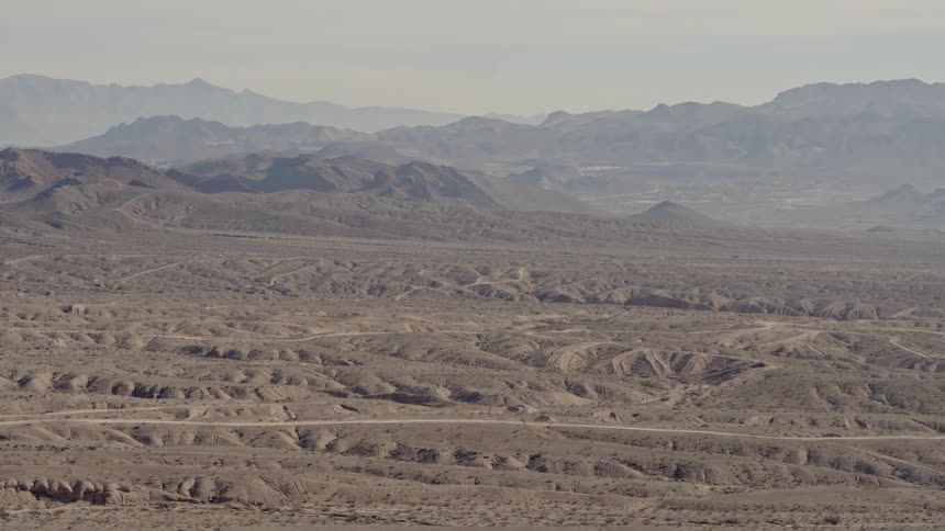 The fog is covering the mountains in the desert