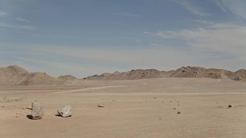 The desert has cross trails moving towards the mountains