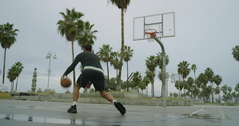 A man shooting and missing a basket