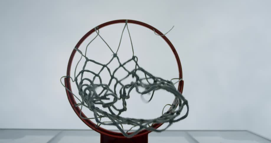 A basketball going into a hoop