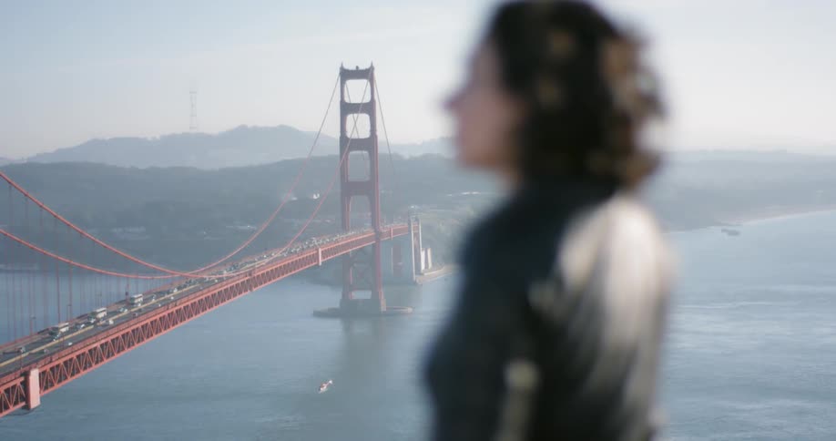 A woman looks out over the golden gate bridge