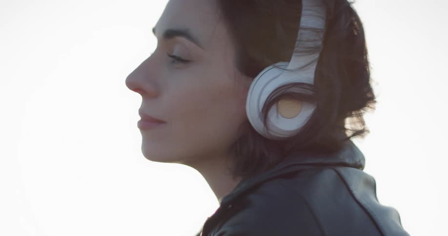 A woman putting on headphones