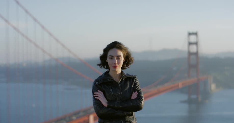 Woman stands in front of san francisco golden gate bridge