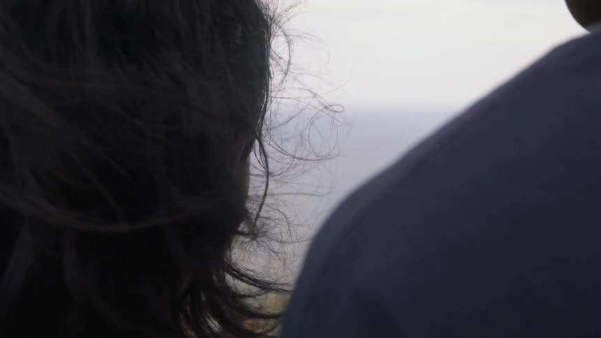 Long Hair Gently Blowing in Breeze Through a Scenic Natural Landscape.